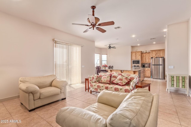 tiled living room featuring ceiling fan