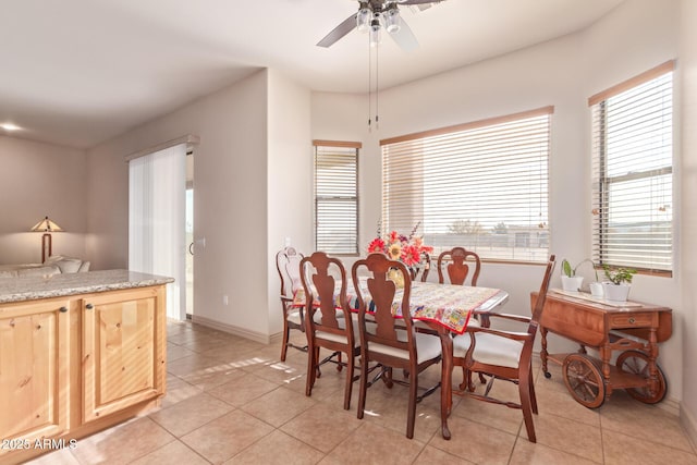 dining space featuring ceiling fan and light tile patterned floors