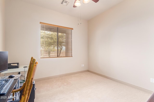 office space with ceiling fan and light carpet