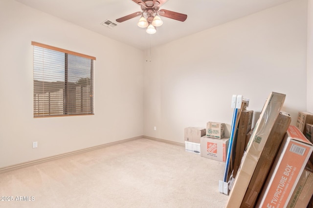 carpeted spare room featuring ceiling fan