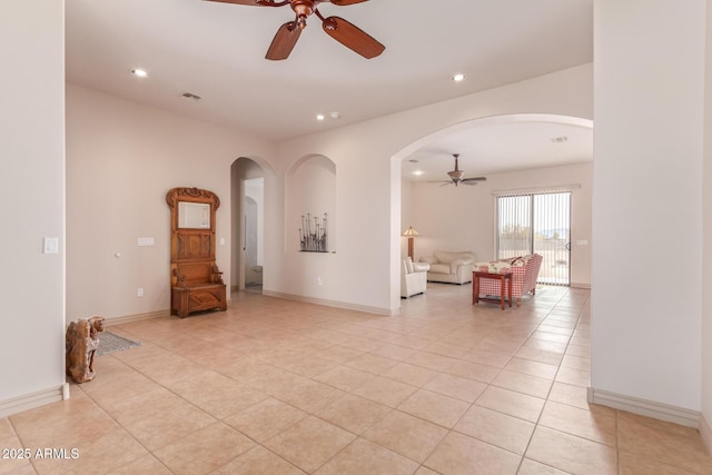 tiled living room with ceiling fan