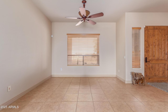 empty room featuring ceiling fan and light tile patterned floors