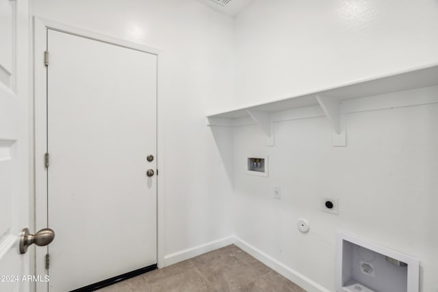 clothes washing area with hookup for a washing machine, hookup for an electric dryer, gas dryer hookup, and baseboards