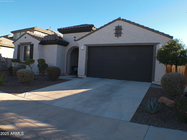 mediterranean / spanish-style home with a garage