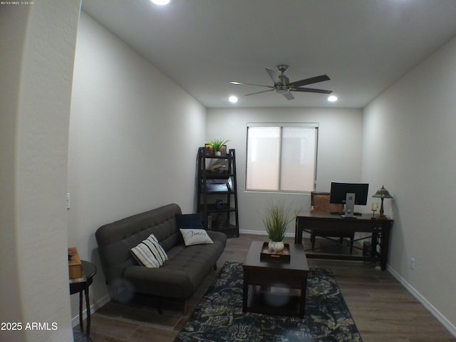 living room featuring ceiling fan and hardwood / wood-style floors