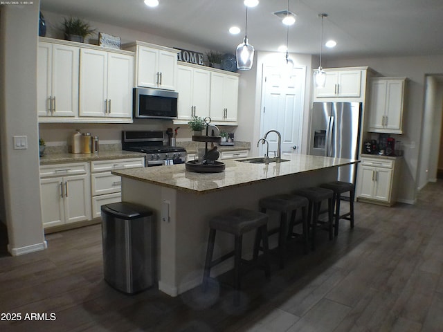 kitchen featuring sink, white cabinets, a center island with sink, and appliances with stainless steel finishes