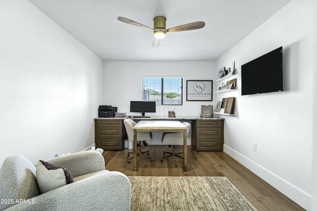 office space featuring baseboards, ceiling fan, and dark wood-style flooring