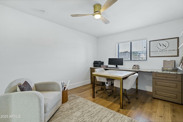 office with light wood-type flooring, a ceiling fan, and baseboards