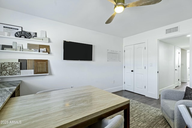 office with visible vents, ceiling fan, wood finished floors, and baseboards