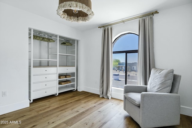 sitting room with wood finished floors and baseboards