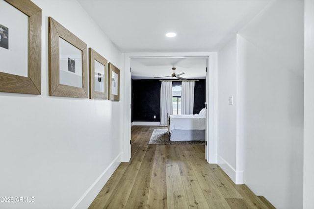 hall with recessed lighting, baseboards, and light wood-style floors
