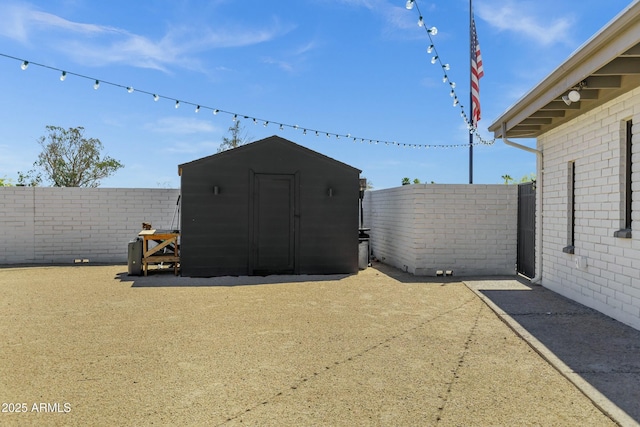 exterior space featuring a fenced backyard, an outbuilding, and a storage shed