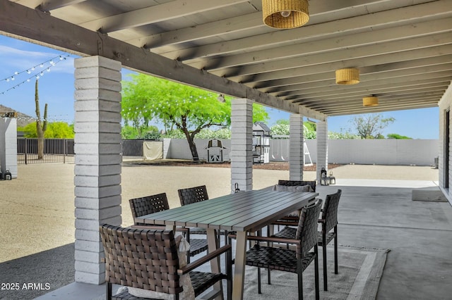 view of patio featuring a fenced backyard and outdoor dining area