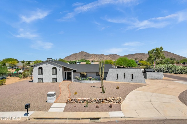 view of front of property featuring a mountain view and brick siding