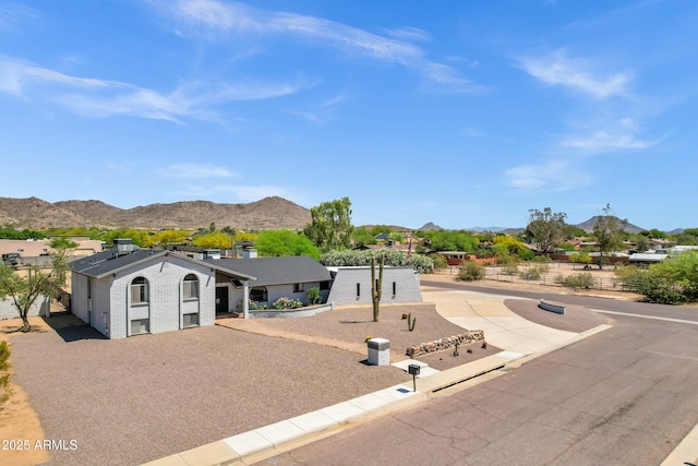single story home featuring a mountain view and brick siding