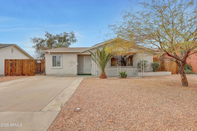 view of front of home with fence and stucco siding