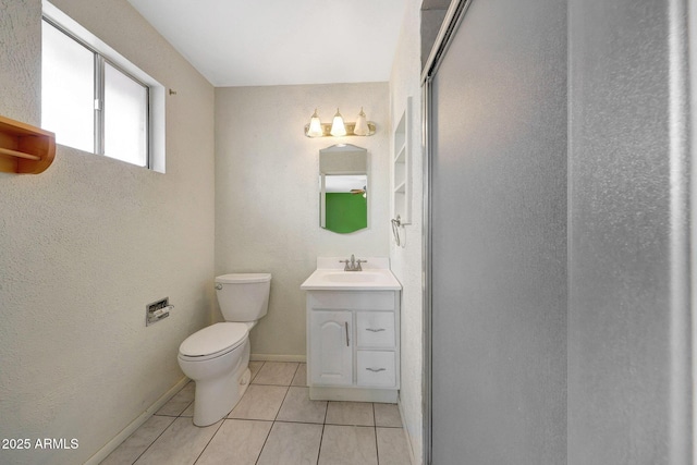 bathroom featuring toilet, tile patterned flooring, baseboards, and vanity