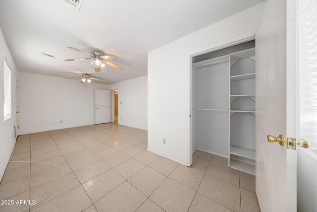 unfurnished bedroom featuring light tile patterned floors, ceiling fan, and visible vents