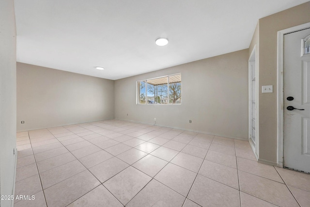 unfurnished room featuring light tile patterned floors