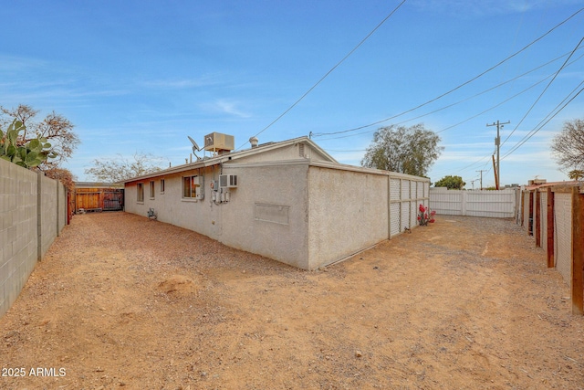 view of home's exterior with a fenced backyard and stucco siding