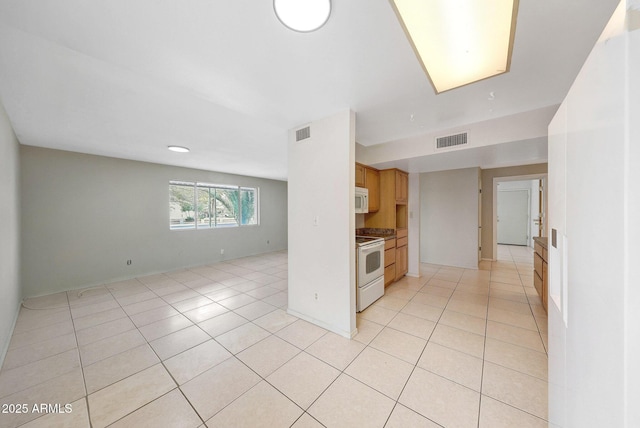 kitchen featuring white appliances, visible vents, open floor plan, and light tile patterned flooring