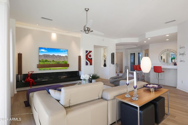 living room featuring ceiling fan and light hardwood / wood-style flooring