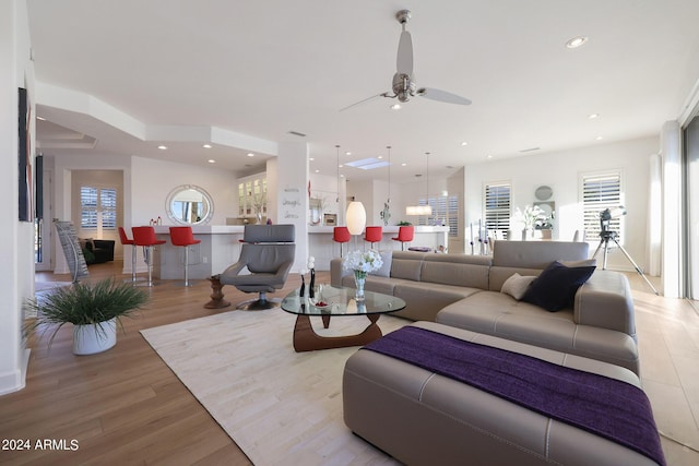 living room featuring ceiling fan and light hardwood / wood-style floors