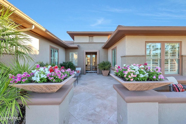 entrance to property with french doors and a patio area