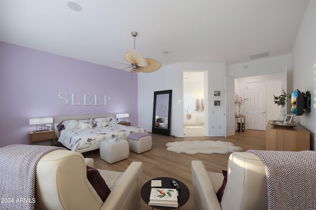 bedroom featuring ceiling fan, light hardwood / wood-style floors, and connected bathroom