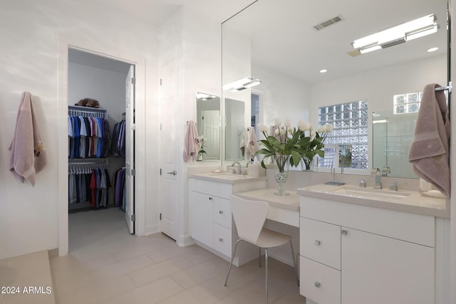 bathroom with tile patterned flooring, vanity, and an enclosed shower