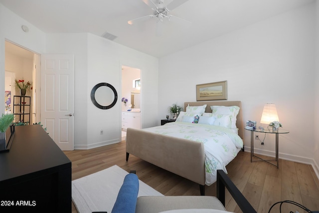 bedroom with connected bathroom, ceiling fan, and light hardwood / wood-style flooring