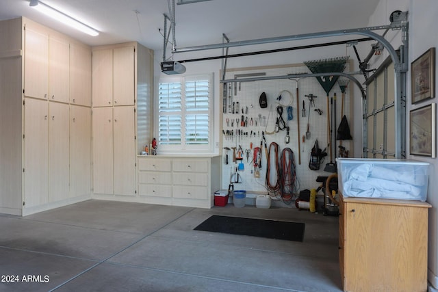 garage with a workshop area and a garage door opener