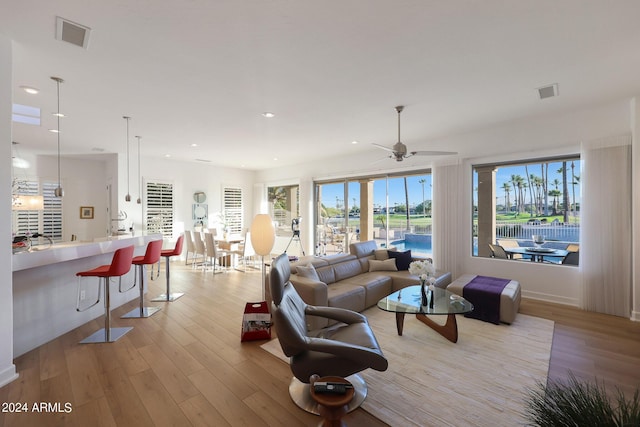 living room featuring light hardwood / wood-style floors and ceiling fan