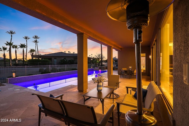 pool at dusk with a patio