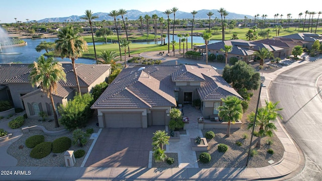 birds eye view of property with a water and mountain view