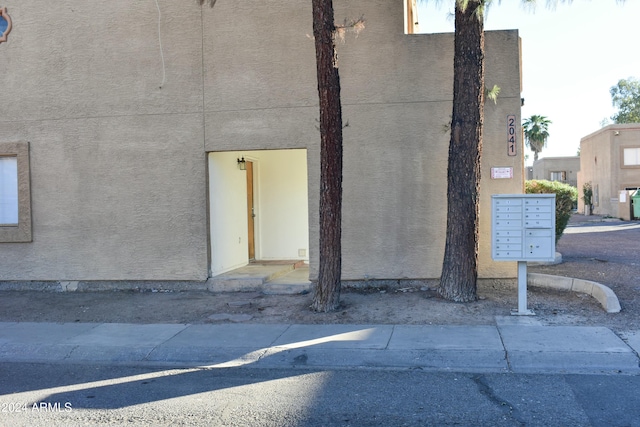 view of side of property featuring mail boxes