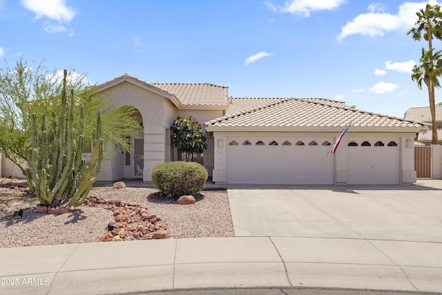 19010 N 35th Way, Phoenix, AZ 85050 - view of front of house featuring a garage, driveway, stucco siding, and a tiled roof