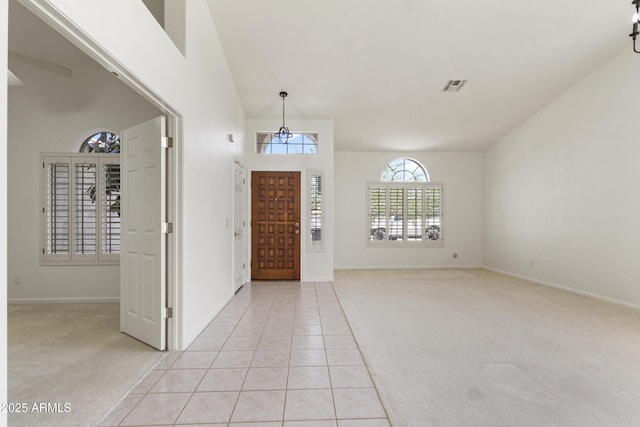 19010 N 35th Way, Phoenix, AZ 85050 - entrance foyer with light colored carpet, baseboards, light tile patterned flooring, and a chandelier
