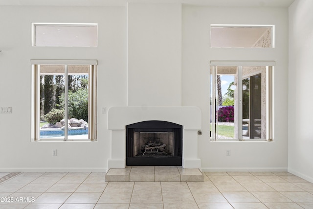 19010 N 35th Way, Phoenix, AZ 85050 - unfurnished living room featuring a fireplace with raised hearth, healthy amount of natural light, and tile patterned floors