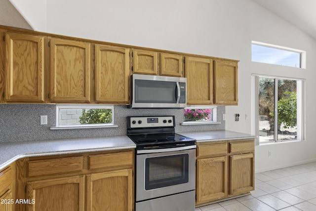 19010 N 35th Way, Phoenix, AZ 85050 - kitchen with appliances with stainless steel finishes, decorative backsplash, high vaulted ceiling, light countertops, and light tile patterned floors