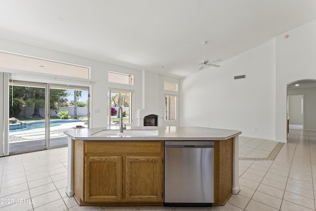 19010 N 35th Way, Phoenix, AZ 85050 - kitchen featuring stainless steel dishwasher, a sink, open floor plan, light tile patterned floors, and arched walkways