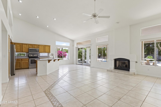 19010 N 35th Way, Phoenix, AZ 85050 - unfurnished living room featuring high vaulted ceiling, light tile patterned flooring, plenty of natural light, a fireplace, and recessed lighting