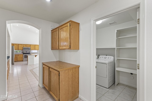 19010 N 35th Way, Phoenix, AZ 85050 - laundry room with washer / dryer, light tile patterned floors, arched walkways, and recessed lighting