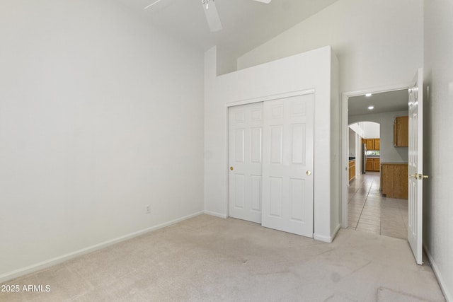 19010 N 35th Way, Phoenix, AZ 85050 - unfurnished bedroom featuring light colored carpet, a closet, lofted ceiling, arched walkways, and baseboards