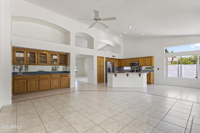 19010 N 35th Way, Phoenix, AZ 85050 - unfurnished living room with a high ceiling, light tile patterned flooring, recessed lighting, a ceiling fan, and a sink