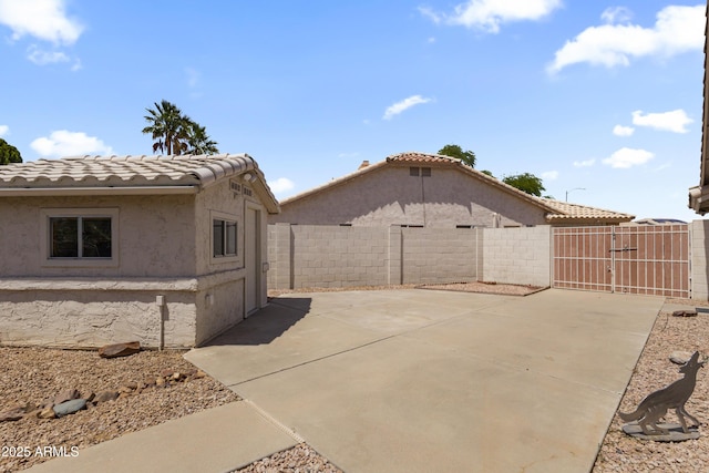 19010 N 35th Way, Phoenix, AZ 85050 - view of side of home featuring a gate, a tile roof, stucco siding, and a patio area