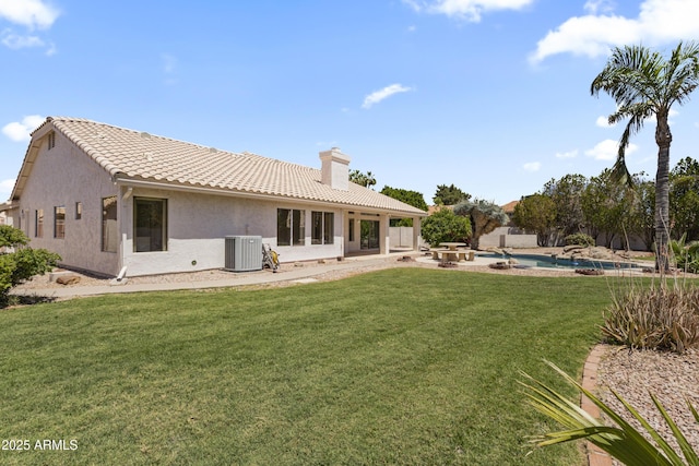 19010 N 35th Way, Phoenix, AZ 85050 - back of property with central AC, a lawn, a chimney, a tiled roof, and stucco siding