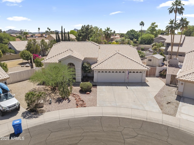19010 N 35th Way, Phoenix, AZ 85050 - mediterranean / spanish-style home with a garage, concrete driveway, a tiled roof, and a residential view