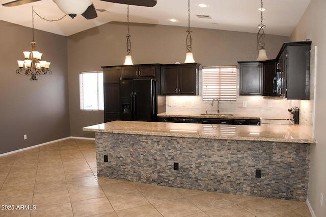 749 N 99th St, Mesa, AZ 85207 - kitchen with black fridge with ice dispenser, a sink, ceiling fan, stove, and light stone counters
