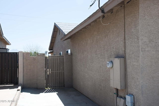 749 N 99th St, Mesa, AZ 85207 - view of side of home with stucco siding and a gate